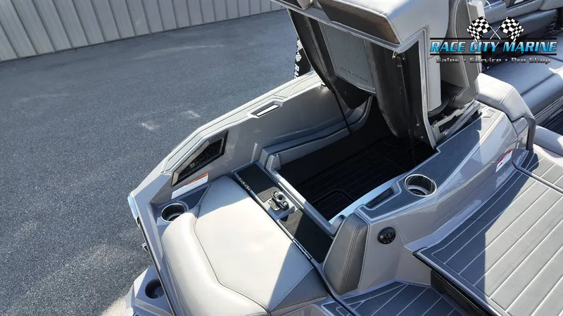 Slide: The Image of The image shows the interior of a 2022 Nautique Super Air Nautique G25 Paragon with gray upholstery and storage space. - 43