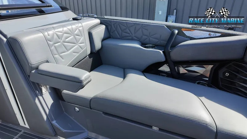 Slide: The Image of The image shows a luxurious gray bench seat with quilted pattern and armrest on a boat. - 32