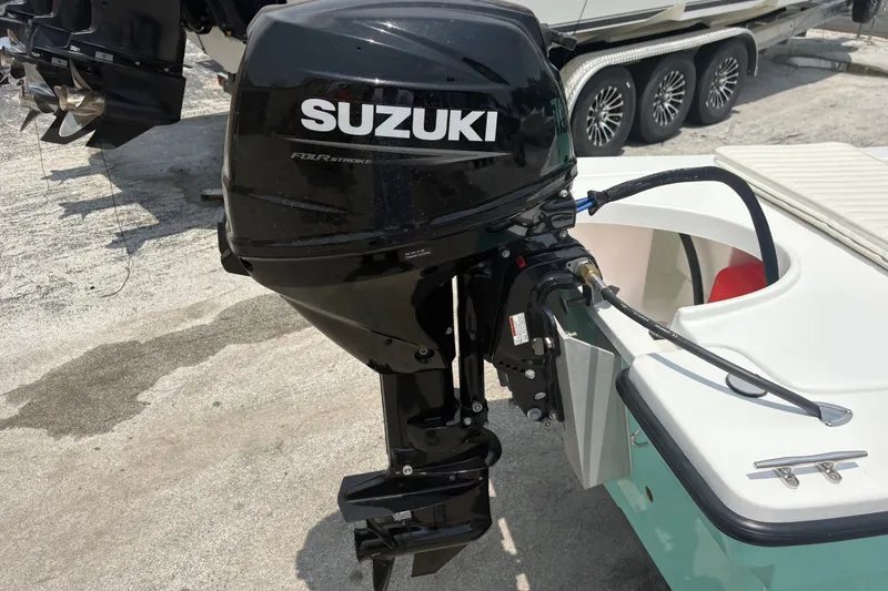 Slide: The Image of Outboard motor on 2025 Exuma 14 Snookaholic boat, featuring Suzuki four-stroke engine. - 5