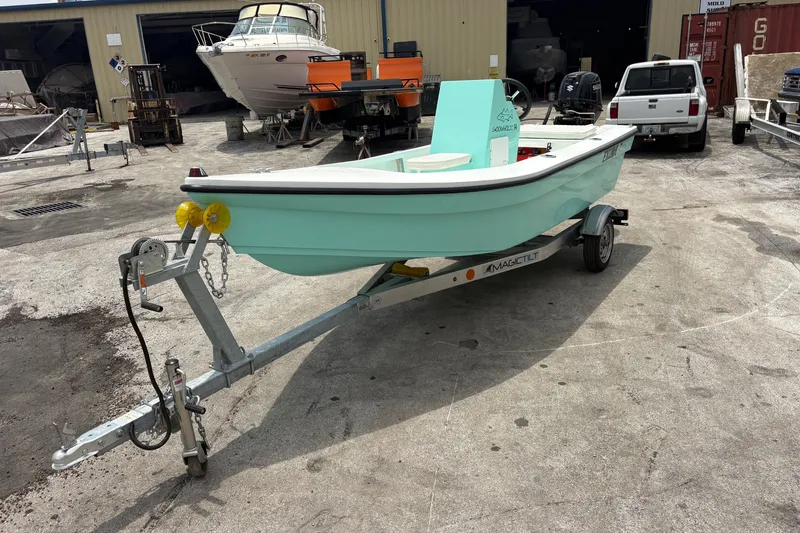 Slide: The Image of 2025 Exuma 14 Snookaholic boat on trailer in a marina setting. - 10