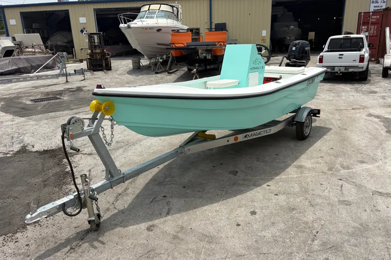 Slide: The Image of 2025 Exuma 14 Snookaholic boat on trailer in a marina setting. - 7