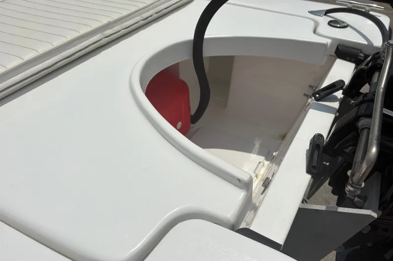 Slide: The Image of Exuma 14 Snookaholic 2025 boat interior, featuring storage compartment and engine details. - 12