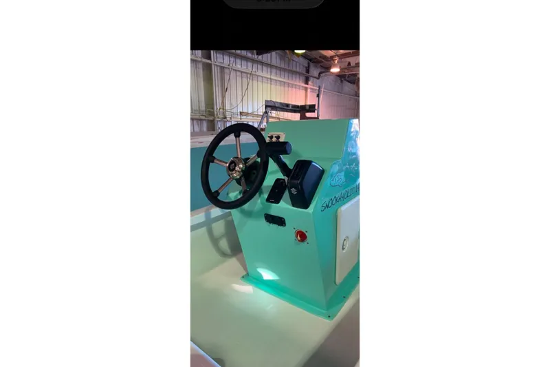 Slide: The Image of Steering console of 2026 Exuma 14 Snookaholic boat in a warehouse setting. - 4