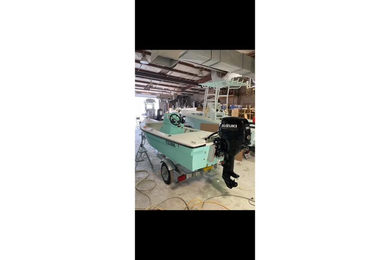 Slide: The Image of 2026 Exuma 14 Snookaholic boat in workshop with Suzuki outboard motor. - 5