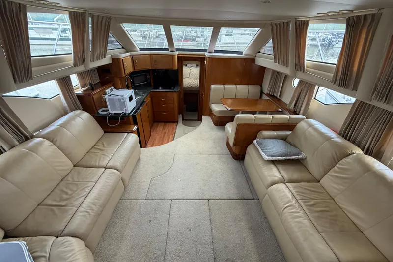 Slide: The Image of Interior of 2005 Carver 396 Aft Cabin Motor Yacht with beige leather seating and kitchenette. - 10