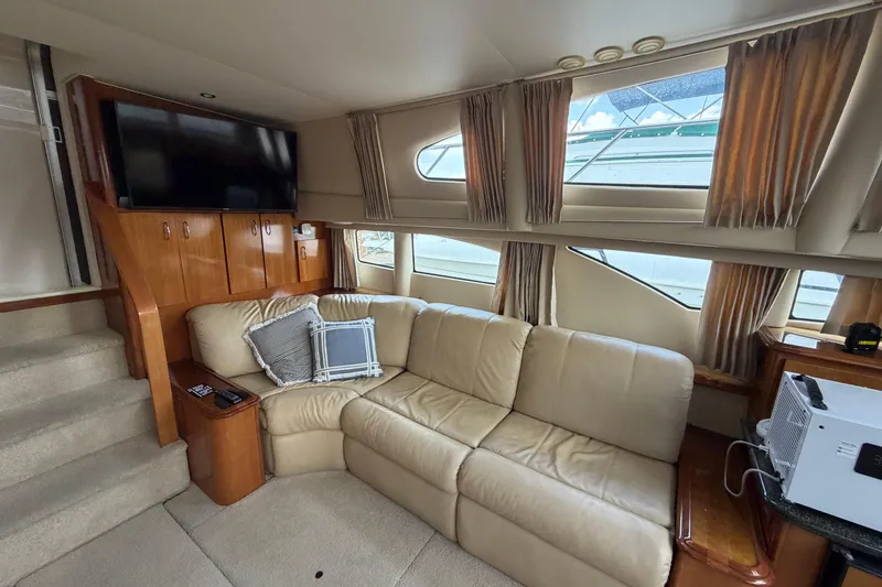 Slide: The Image of Luxurious interior of 2005 Carver 396 Aft Cabin Motor Yacht with plush seating and TV. - 9