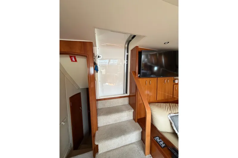 Slide: The Image of Interior of 2005 Carver 396 Aft Cabin Motor Yacht with stairs and wooden cabinetry. - 11