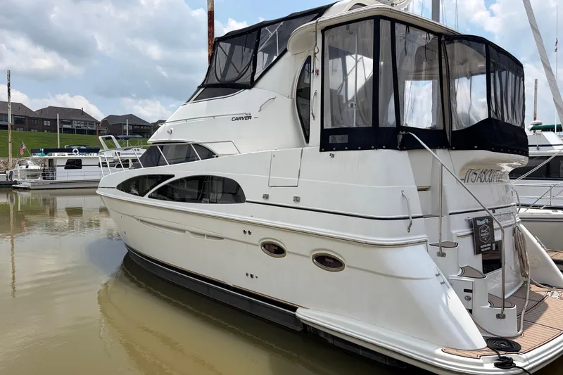 The Image of 2005 Carver 396 Aft Cabin Motor Yacht docked in a marina, showcasing sleek design. - 0