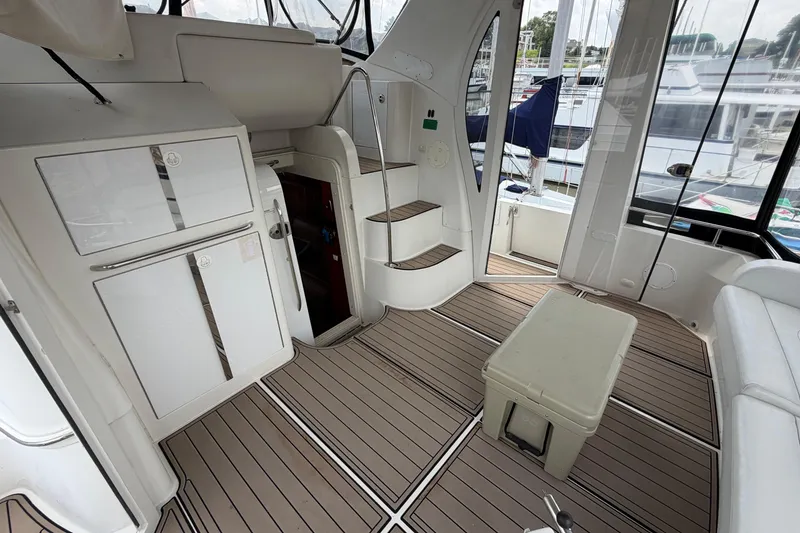 Slide: The Image of 2005 Carver 396 Aft Cabin Motor Yacht interior with stairs, seating, and storage. - 21