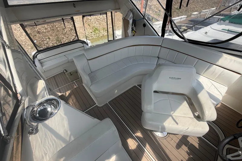 Slide: The Image of Interior of 2005 Carver 396 Aft Cabin Motor Yacht with white seating and wood flooring. - 4