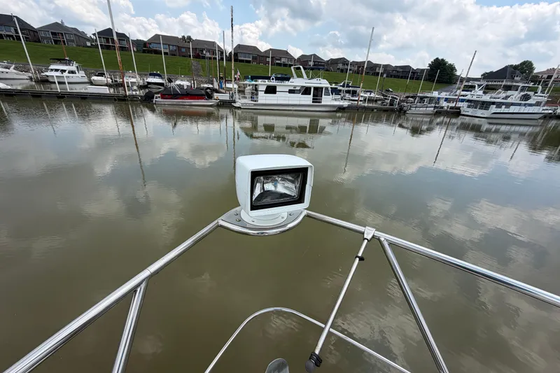 Slide: The Image of Bow view of 2005 Carver 396 Aft Cabin Motor Yacht in a marina setting. - 23
