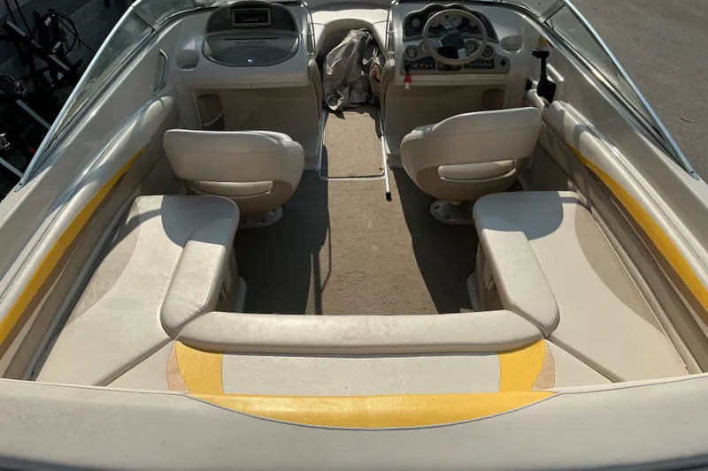 Slide: The Image of 2003 Glastron GX 225 boat interior with beige seating and dashboard view. - 21
