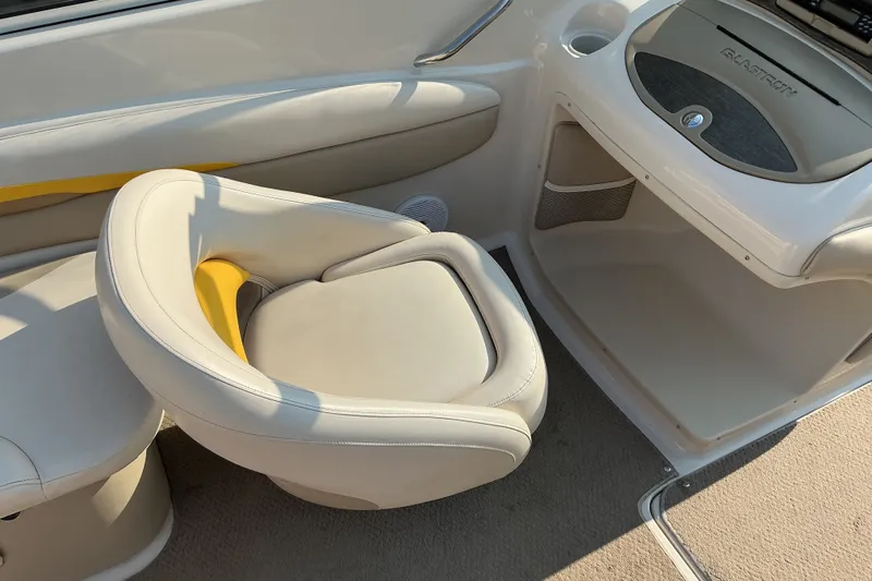 Slide: The Image of 2003 Glastron GX 225 boat interior with beige seating and dashboard. - 16