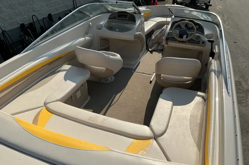 Slide: The Image of 2003 Glastron GX 225 boat interior with beige seating and steering console. - 20