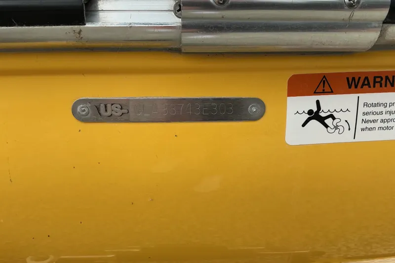 Slide: The Image of Yellow Glastron GX225 2003 boat with warning label and serial number plate. - 9