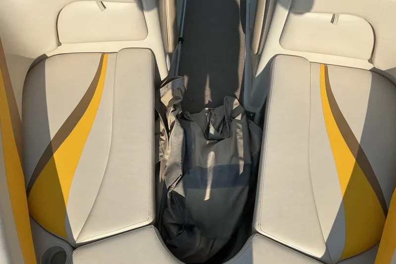 Slide: The Image of 2003 Glastron GX 225 boat interior with yellow and gray seat design. - 13