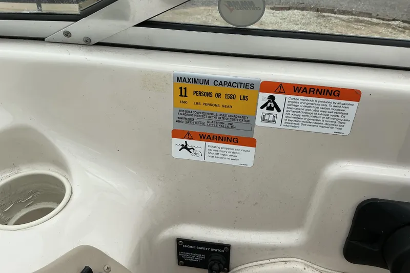 Slide: The Image of 2003 Glastron GX225 boat capacity and safety warnings, including maximum load and carbon monoxide alert. - 6