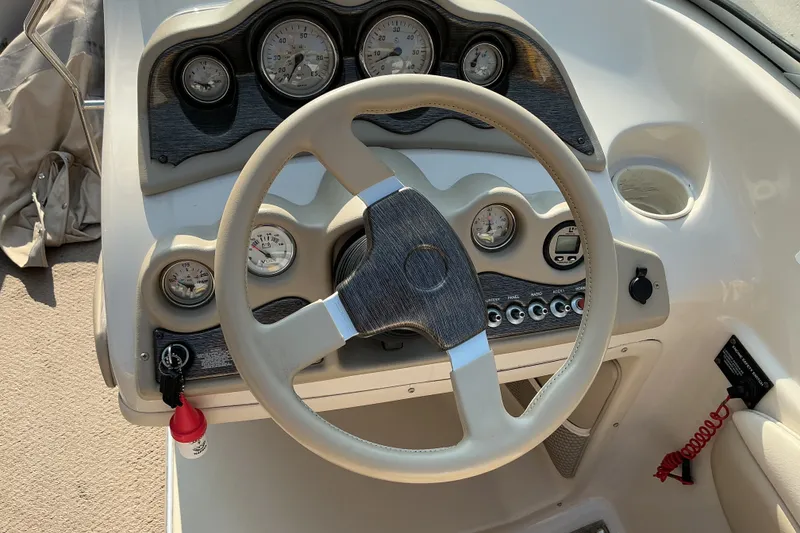Slide: The Image of 2003 Glastron GX 225 boat dashboard with steering wheel and instrument panel. - 18