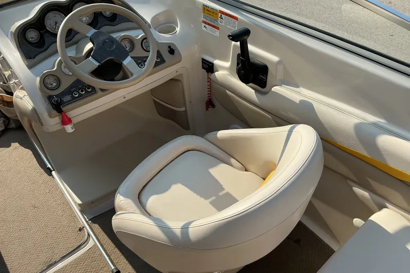 Slide: The Image of 2003 Glastron GX 225 boat interior with steering wheel and control panel. - 17