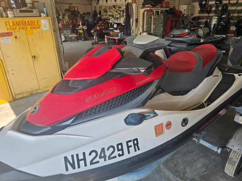 Slide: The Image of A 2010 Sea-Doo GTX 155 in a workshop. It features a red and white color scheme. - 3