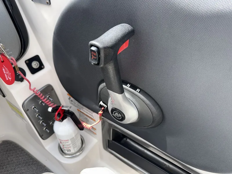 Slide: The Image of Close-up of a boat throttle lever with a fire extinguisher and keys nearby. - 17