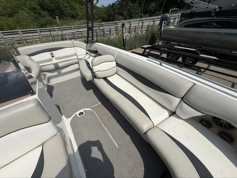 Slide: The Image of The image shows the interior of a 2015 Starcraft 211 SCX with white and gray seating. - 10