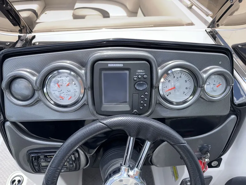 Slide: The Image of The image shows the dashboard of a 2015 Starcraft 211 SCX boat with instruments and steering wheel. - 14