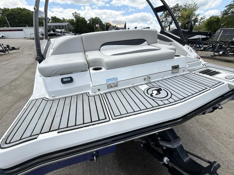 Slide: The Image of The image shows the stern of a 2015 Starcraft 211 SCX boat with gray upholstery. - 16