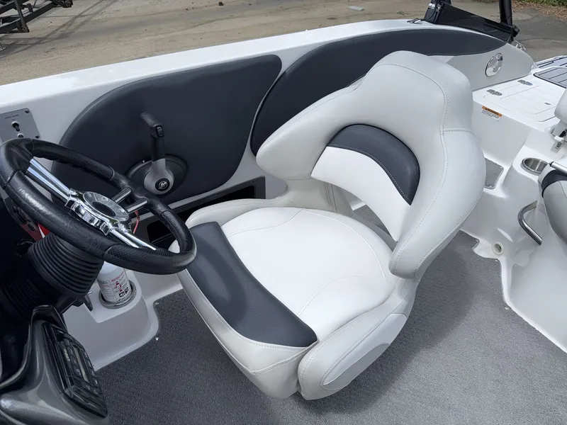 Slide: The Image of A white and gray captain's chair in a 2015 Starcraft 211 SCX boat. - 24