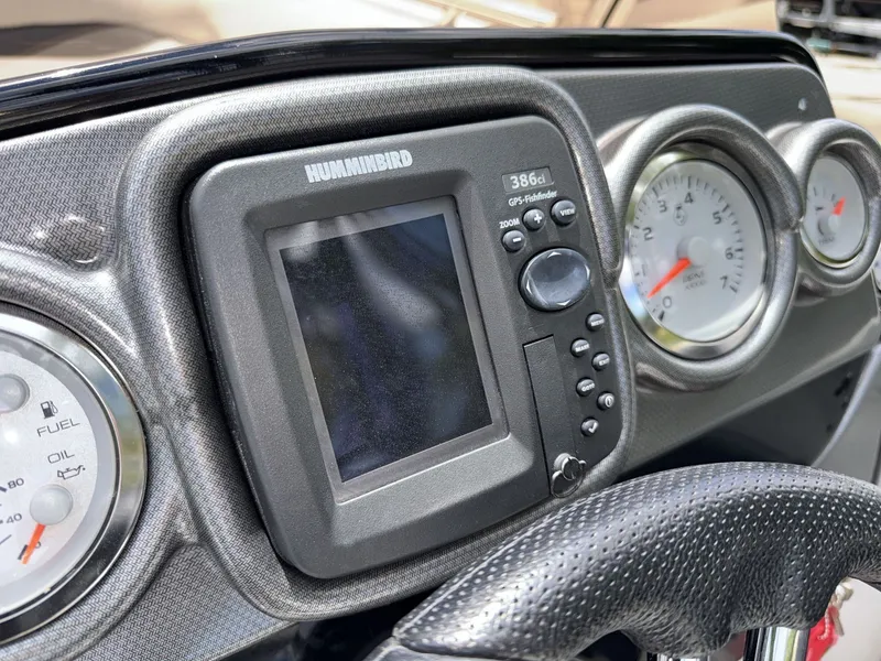 Slide: The Image of Close-up of a boat dashboard featuring a Humminbird fish finder and various gauges. - 29
