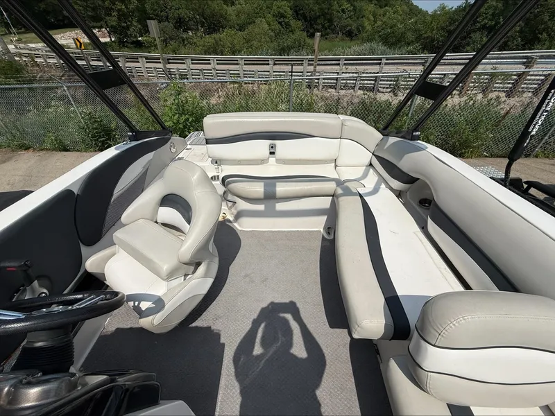 Slide: The Image of The image shows the cockpit of a 2015 Starcraft 211 SCX with white and gray seating. - 11
