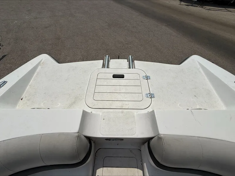 Slide: The Image of The image shows the stern of a Starcraft 211 SCX boat with a large, white sun pad. - 12
