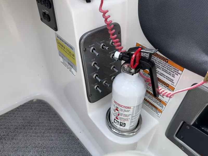 Slide: The Image of A fire extinguisher is mounted in a holder on a Starcraft 211 SCX boat. - 26