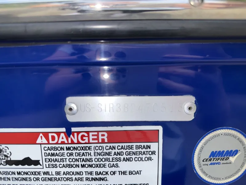 Slide: The Image of Close-up of a boat hull with warning labels and a serial number. - 28