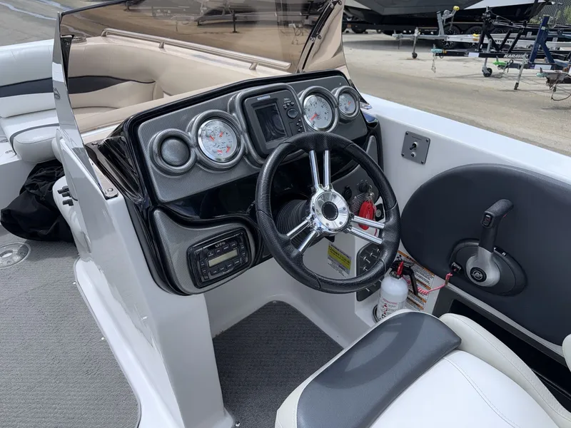 Slide: The Image of The image shows the cockpit of a 2015 Starcraft 211 SCX with a modern dashboard and steering wheel. - 18