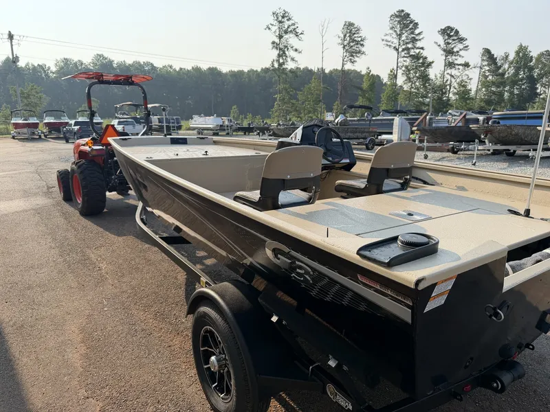 Slide: The Image of A G3 Gator Tough 18SC-90 SHO boat on a trailer, towed by a tractor, surrounded by trees. - 8