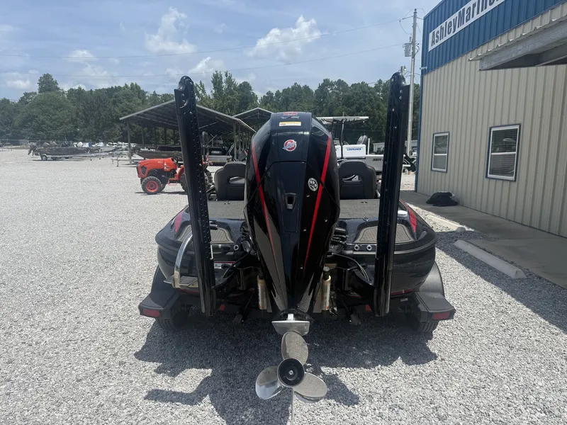 Slide: The Image of A 2024 Nitro Z Series Z19 boat with a powerful engine and two poles, parked on gravel. - 7