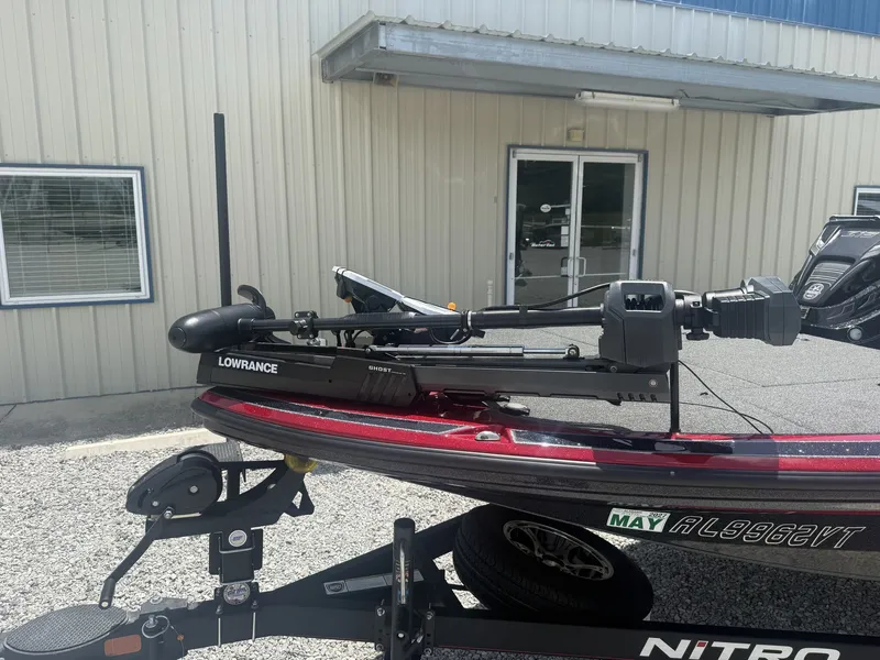 Slide: The Image of A Nitro Z Series Z19 boat with a Lowrance device, on a trailer in front of a building. - 2