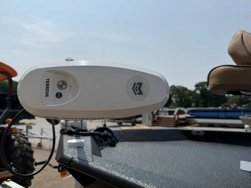 Slide: The Image of Close-up of a boat part with a Minn Kota Terrova motor. Boats and a trailer are visible in the background. - 4