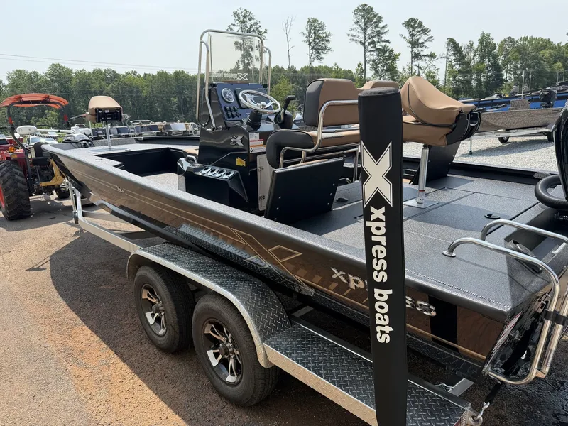 Slide: The Image of A 2027 Xpress Hyper-Lift Bay Series H24B-CUSTOM SEADECK on a trailer. It features a modern cockpit and comfortable seating. - 5