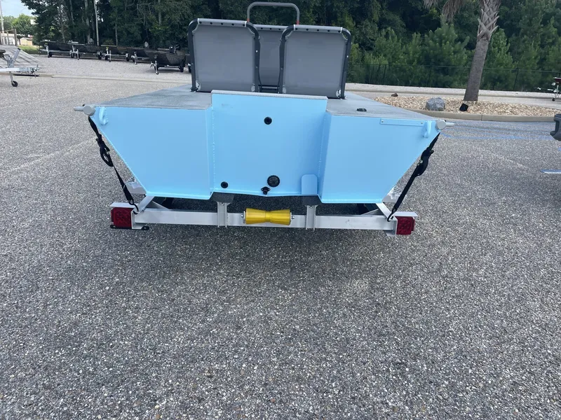 Slide: The Image of The image shows the blue stern of an XTREME BOATS Micro-X 1748 MICRO SKIFF on a trailer. - 3