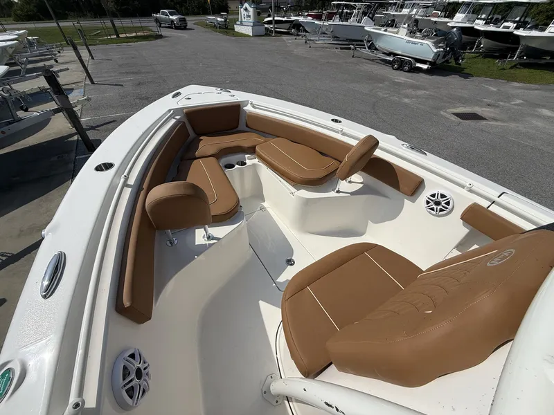 Slide: The Image of The image shows the bow area of a Key West 239 FS boat with brown cushions. - 5