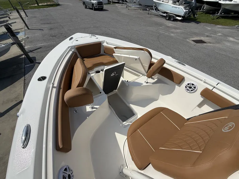 Slide: The Image of The image shows the bow of a Key West 239 FS boat with brown upholstery. - 4