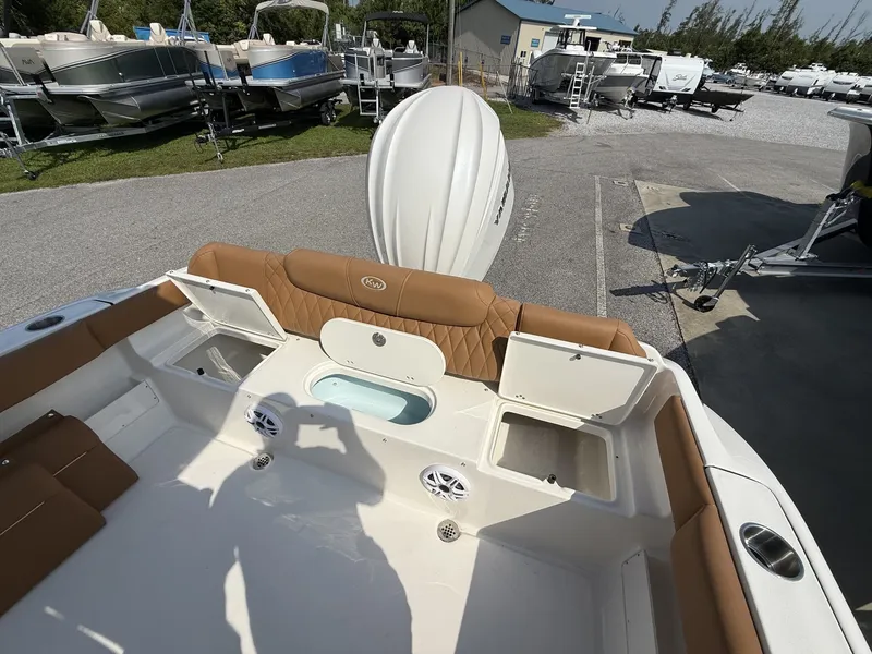 Slide: The Image of The image shows the cockpit of a Key West 239 FS boat with brown upholstery and storage compartments. - 13