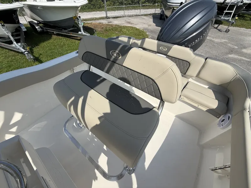 Slide: The Image of The image shows the beige upholstery and stainless steel fittings of a Key West 203 FS boat. - 11