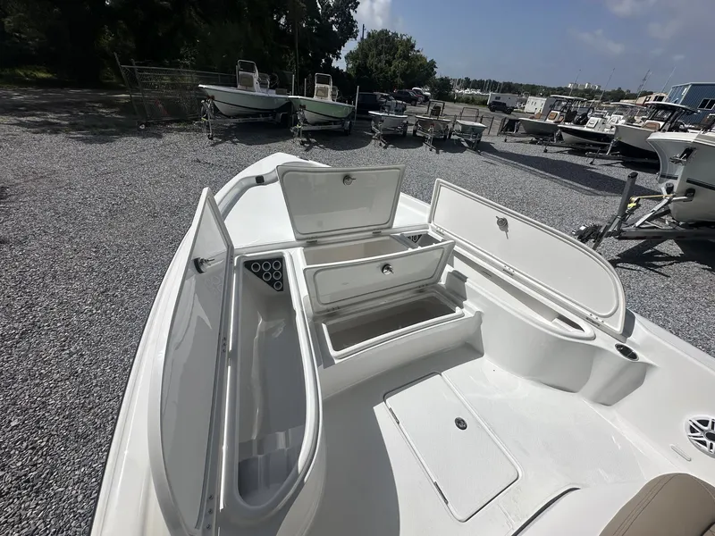 Slide: The Image of The image shows the deck of a Blazer PureBay 2400 boat with multiple storage compartments. - 6