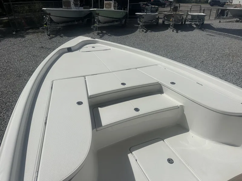 Slide: The Image of The image shows the deck of a 2026 Blazer PureBay 2400 boat with white storage compartments. - 8