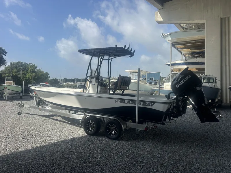 Slide: The Image of A 2026 Blazer PureBay 2400 sits on a trailer under a covered area. - 10