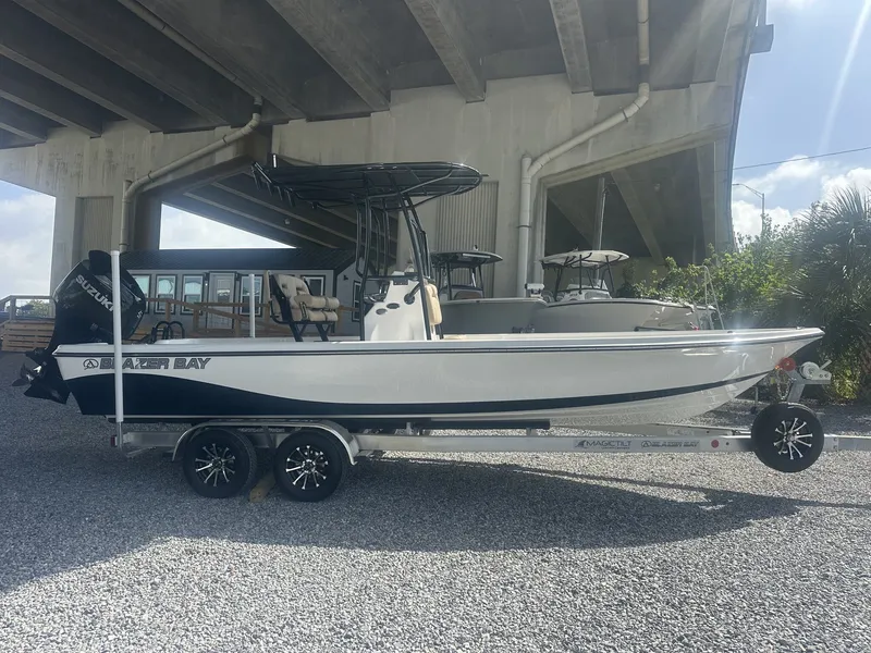 The Image of A 2026 Blazer PureBay 2400 sits on a trailer under a bridge. - 1