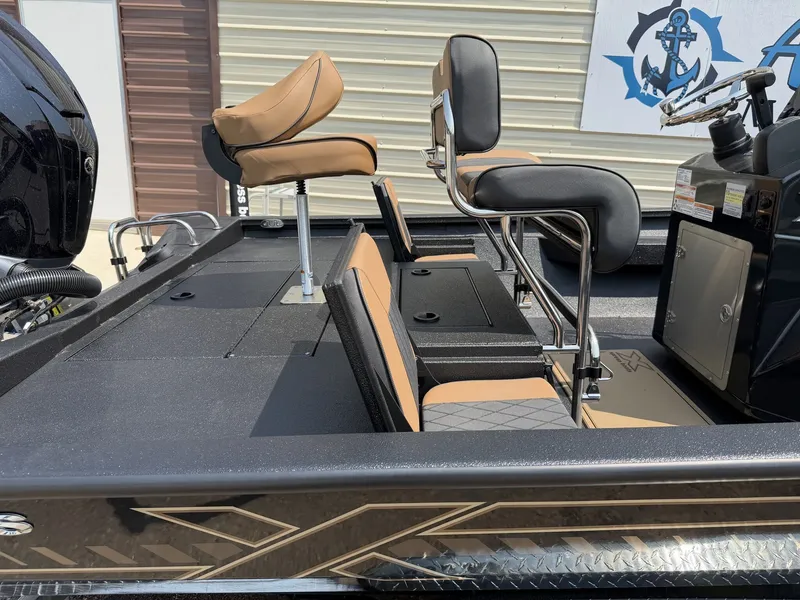Slide: The Image of The image shows the cockpit of an Xpress Hyper-Lift Bay Series H24B boat with brown seats and a black deck. - 8